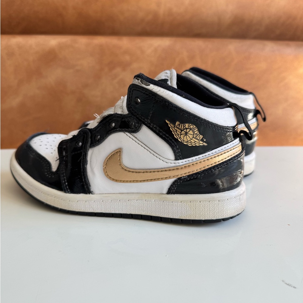 Black and White Jordans with Gold Accents